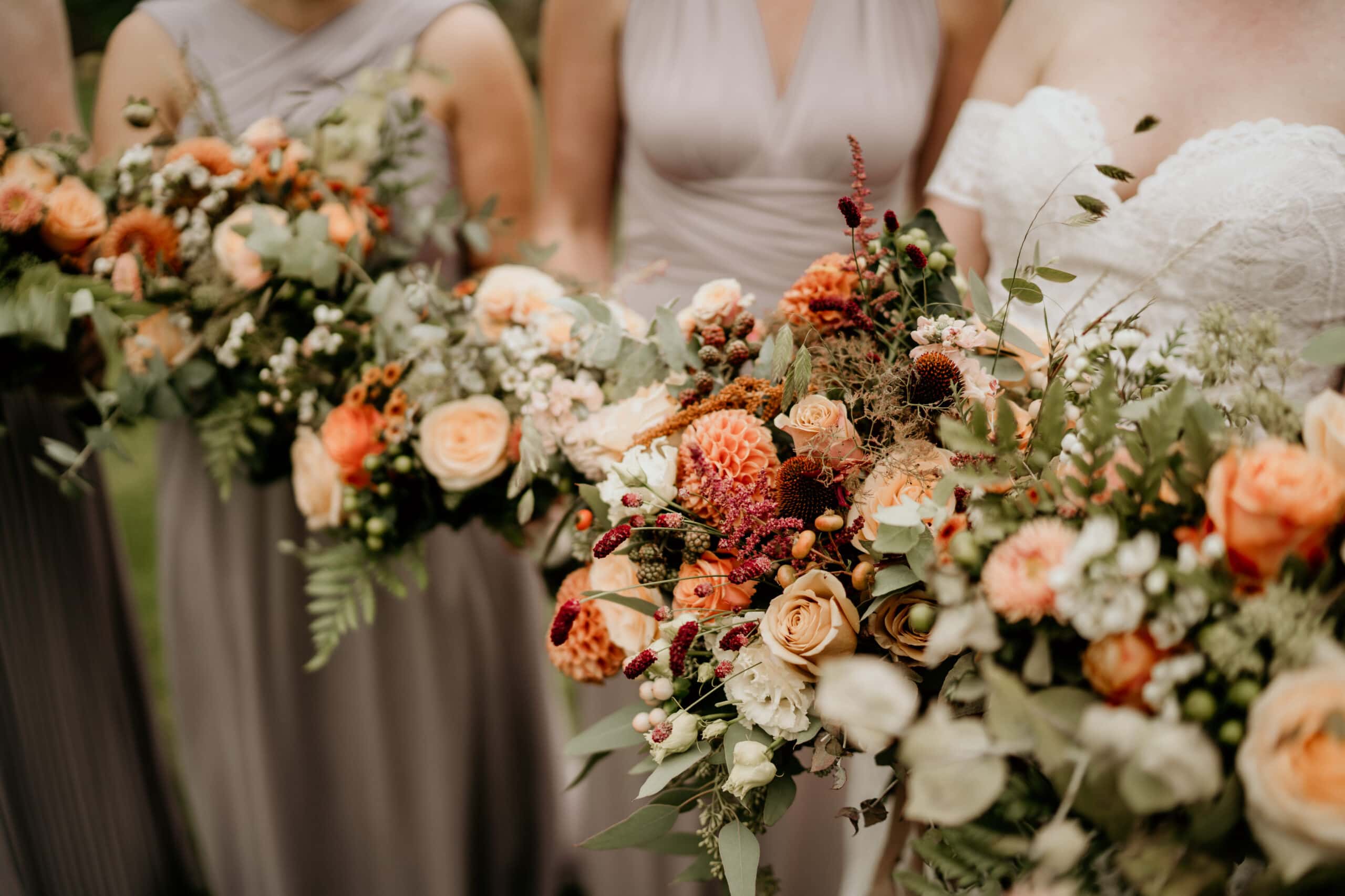 A selection of colourful summer bouquets, one bridal and three bridesmaid. Each are made up of florals in varying shades of hot pink, coral and ivory, with plenty of greenery too.